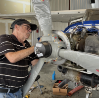 Photo of Bob Davis working on a propeller.